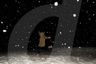 Snowfall at night lit up by a flashgun