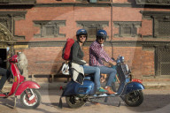 A tourist on a scooter outside a Newari building in Patan in Kathmandu in Nepal