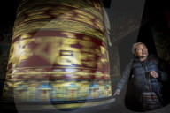 A TIbetan lady sends her prayers spiralling up to heaven by spinning a prayer wheel in the Everest region of Nepal