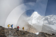 A team of four climbers make their way to Ama Dablam base camp, the 6,856m peak seen here in the distance they will be climbing