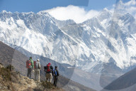 Trekkers look up at Everest, the distant peak on the left), with Nuptse and Lhotse in Nepal