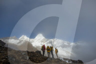 A team of four climbers make their way to Ama Dablam base camp, the 6,856m peak seen here in the distance they will be climbing