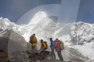 A team of four climbers make their way to Ama Dablam base camp, the 6,856m peak seen here in the distance they will be climbing