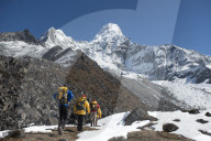 A team of four climbers make their way to Ama Dablam base camp, the 6,856m peak seen here in the distance they will be climbing