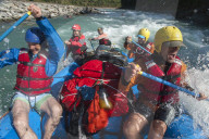 Rafters get splashed as they go through some big rapids on the Karnali river in Nepal