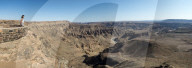 A woman looks into The Fish River Canyon in southern Namibia, Africa