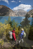 Trekkers look out at the turquoise blue Phoksundo lake in Dolpa in Nepal