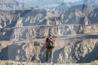 A man stands on the edge of the Fish River Canyon, Namibia, Africa