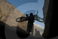 Working hard to play hard: a moutain biker carries his bike into the Himalayas in Nepal
