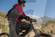 A mountain biker in the Tsum valley stops to check out the view in Nepal