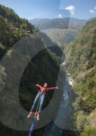 A girl jumps a bungy backwards in Nepal