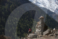A trekker stops by a chorten in the Tsum valley in Nepal