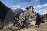 A mountain biker in the Tsum valley stops to check out the view in Nepal