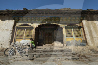A mountain biker takes a well earned rest at Mu Gompa - the last village in the Tsum valley in Nepal