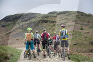 Mountain bikers stop to consider their route around Loughrigg fell in the English Lake District
