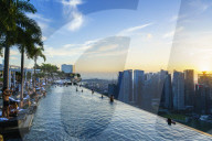 Infinity pool on the roof of the Marina Bay Sands Hotel with spectacular views over the Singapore skyline at sunset, Singapore, Southeast Asia, Asia