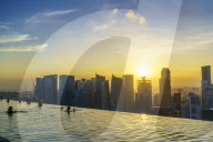 Infinity pool on the roof of the Marina Bay Sands Hotel with spectacular views over the Singapore skyline at sunset, Singapore, Southeast Asia, Asia