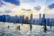 Infinity pool on the roof of the Marina Bay Sands Hotel with spectacular views over the Singapore skyline at sunset, Singapore, Southeast Asia, Asia