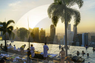 Infinity pool on the roof of the Marina Bay Sands Hotel with spectacular views over the Singapore skyline at sunset, Singapore, Southeast Asia, Asia