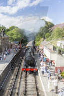Goathland station and a steam locomotive pulling in from Grosmont, on the North Yorkshire Moors Steam Railway, Goathland, Yorkshire, England, United Kingdom, Europe