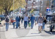 Members of the public enjoy the sunshine in London.