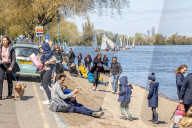 Members of the public enjoy the sunshine in London.