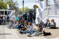 Members of the public enjoy the sunshine in London.