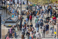 Members of the public enjoy the sunshine in London.