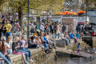 Members of the public enjoy the sunshine in London.