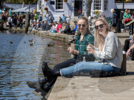 Members of the public enjoy the sunshine in London.