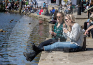 Members of the public enjoy the sunshine in London.