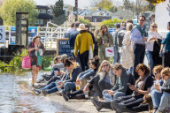 Members of the public enjoy the sunshine in London.