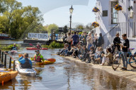 Members of the public enjoy the sunshine in London.