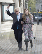 Boris Johnson and Carrie Symonds arrive to vote today in Westminster.