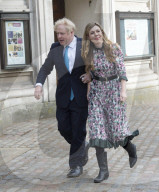 Boris Johnson and Carrie Symonds arrive to vote today in Westminster.