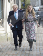 Boris Johnson and Carrie Symonds arrive to vote today in Westminster.