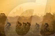 FEATURE -  Radfahrer bahnen sich bei Sonnenaufgang ihren Weg durch den Richmond Park, London