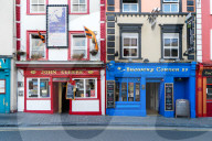 Colorful building fronts of traditional beer pubs in Kilkenny, Ireland.
