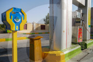 Two dominant themes of religion and oil meet at the petrol station, where there is always a religious donation box, Varzaneh, Ir