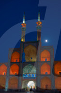 Amir Chakhmagh Complex floodlit with moon, Yazd, Iran