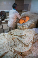 Traditional baker at work at his oven, Ramsar, Iran
