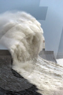 Huge waves crash against the harbour wall at Porthcawl, Bridgend, Wales, UK.