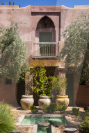 Typical moroccan architecture, riad adobe walls , fountain and flower pots, Morocco