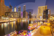 Dubai Marina skyline and tourist boats at night, Dubai City, United Arab Emirates, Middle East