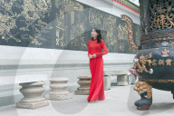 South East Asia, Vietnam, Ho Chi Mihn City (Saigon), Cholon, Nghia An Hoi Quan Pagoda, woman wearing aoi dai dress (MR)