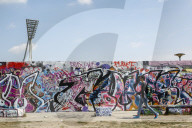 People by the Berlin Wall in Mauerpark, Prenzlauer Berg, Berlin, Germany.