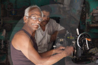 Man repairing an old sewing machind in the city of Jodhpur