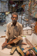 Man selling traditional belts and clothing in the city of Jaipur