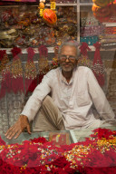 Man in shop selling traditional decorative items in Jaipur