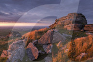 Evening sunlight illuminates West Mill Tor on Dartmoor, Devon, England. Summer (August) 2015.